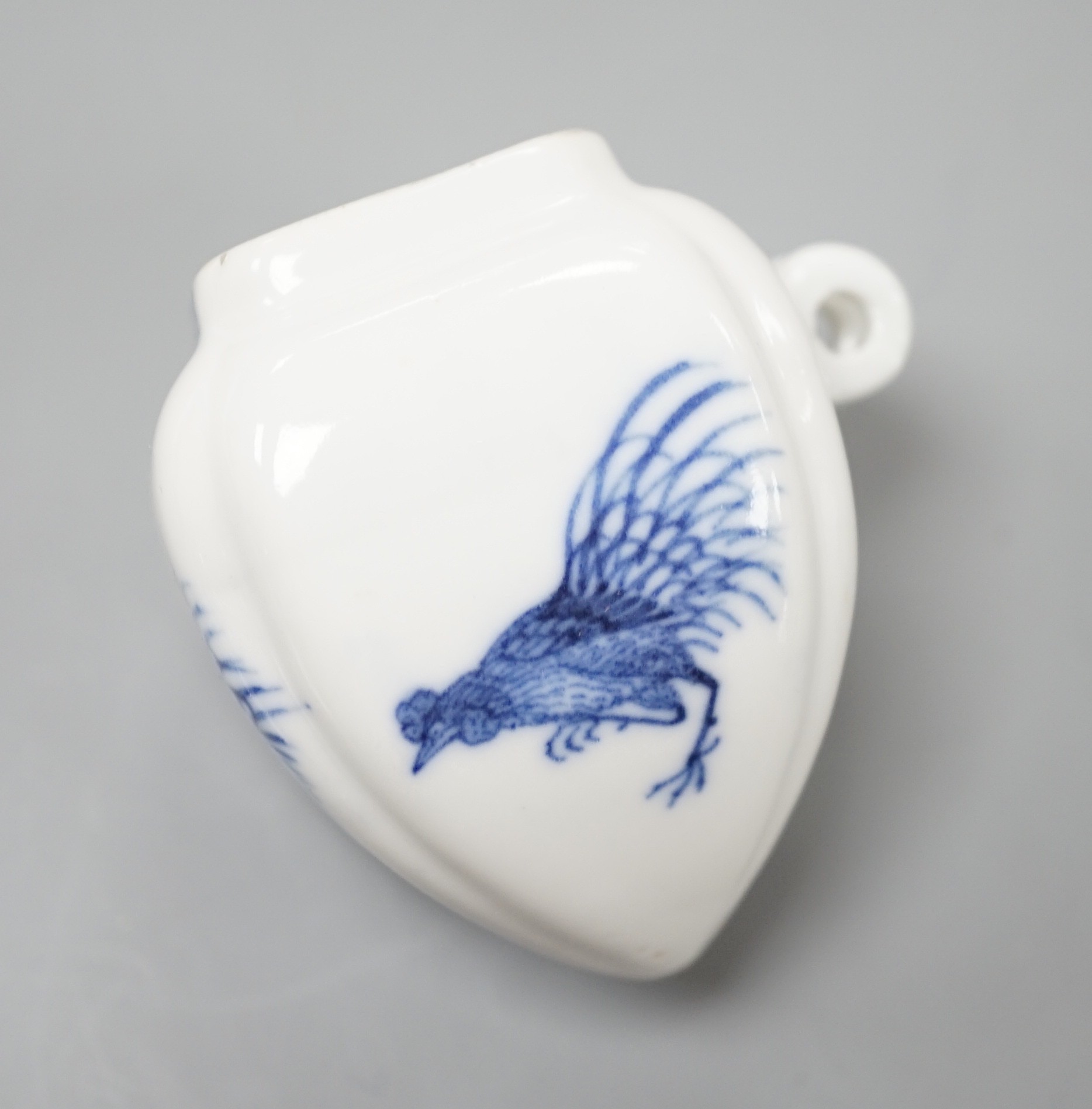 A Chinese blue and white bird feeder, Kangxi mark, 6cms high.